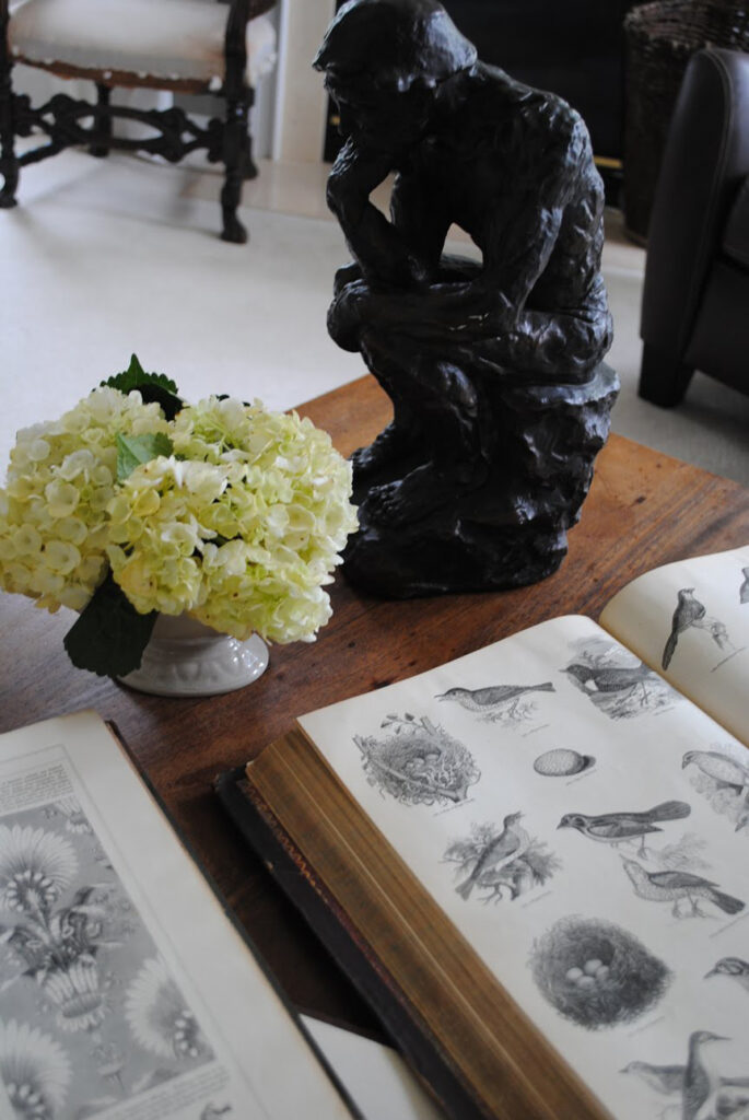 Photo of small statue and old books