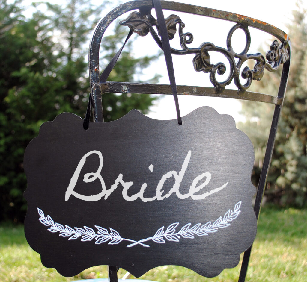 Chalkboard on outdoor chair with Bride written on it