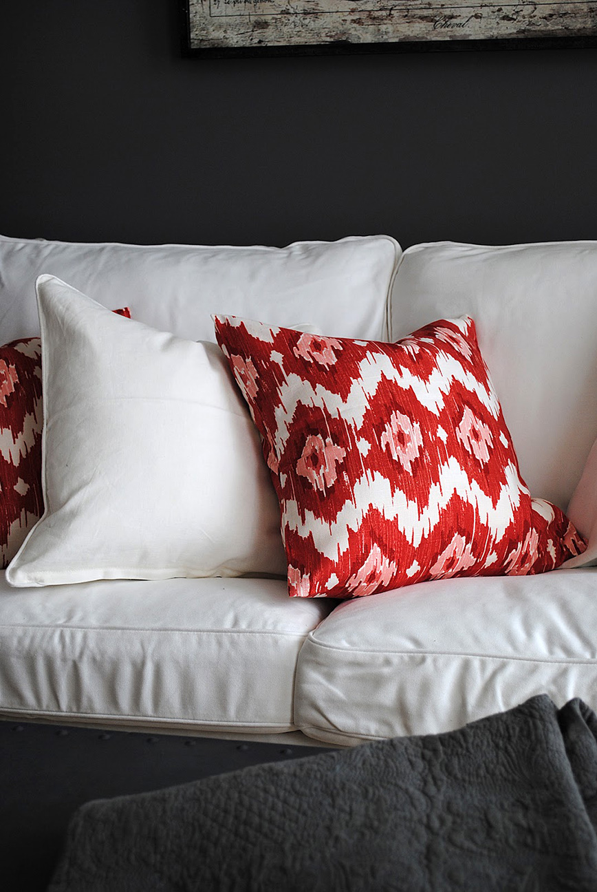 Red ikat pillow on white sofa