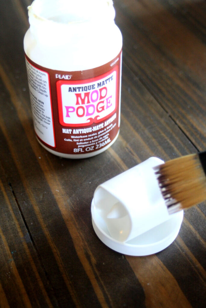 Adding Mod Podge to Candle