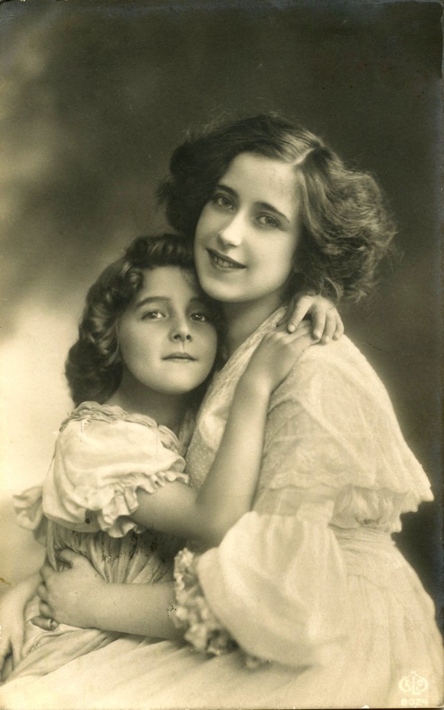 A woman holding a baby posing for the camera