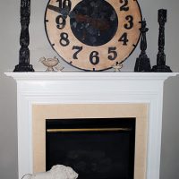 fireplace with clock and lion statue