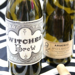 A close up of a bottle of wine with halloween labels