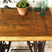 sewing table with pig on it and bottles and plant