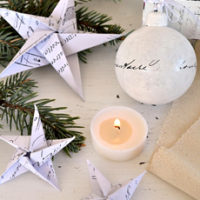 French paper star ornaments with christmas ball and candle