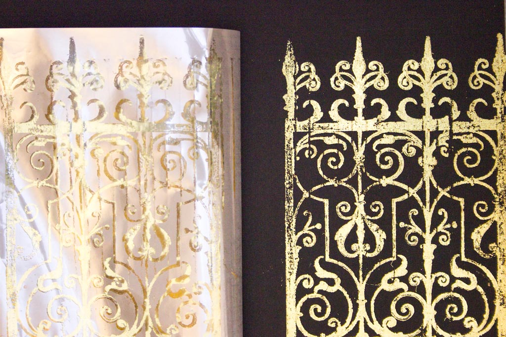 pulling back foil to reveal gold stamped iron fence