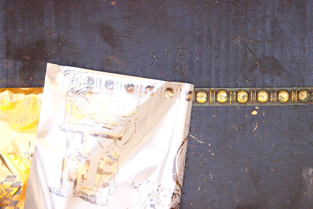pulling back foil to reveal gold foiled decorative trim