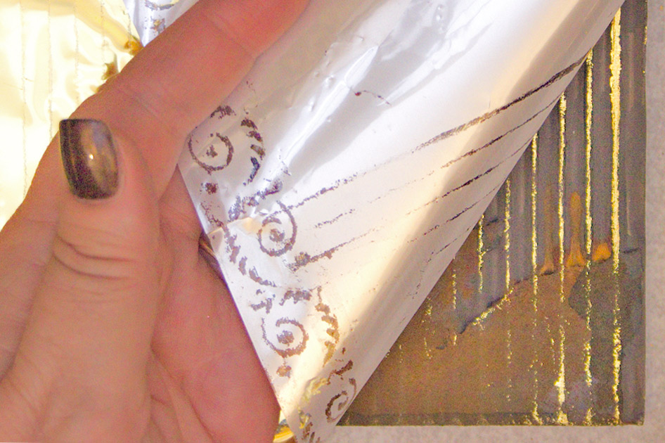 peeling back gold foil from cardboard