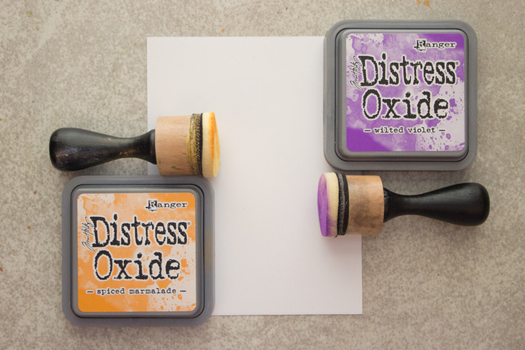 tins of tim holtz distress oxide inks with paper and foam applicators