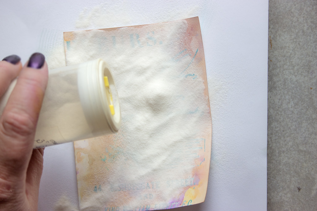 adding embossing powder to paper