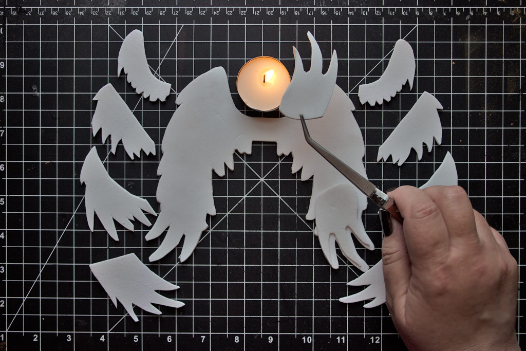 Holding foam wings over candle