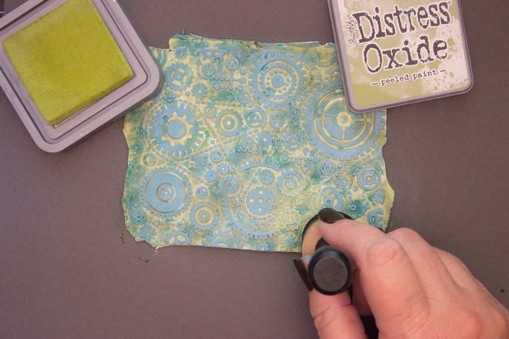 adding distress oxide ink to clay with foam brush