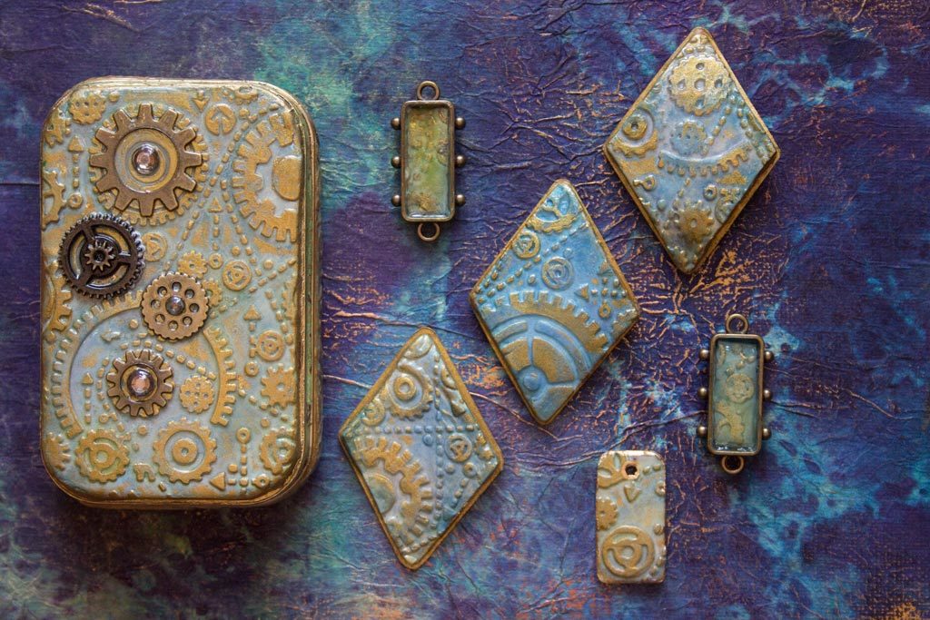finished Embossed Paper clay jewelry and altoid tin