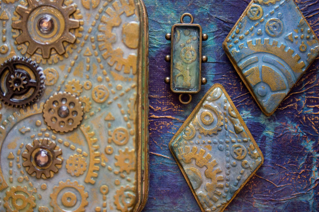 finished Embossed Paper clay jewelry and altoid tin