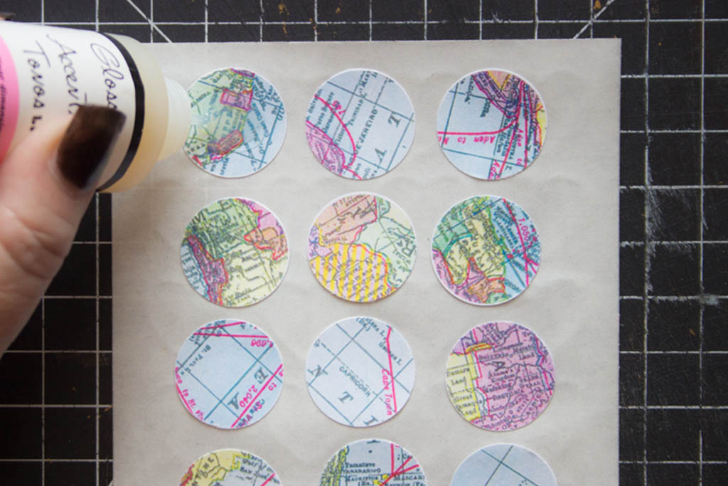 cut out paper circles, adding glossy accents