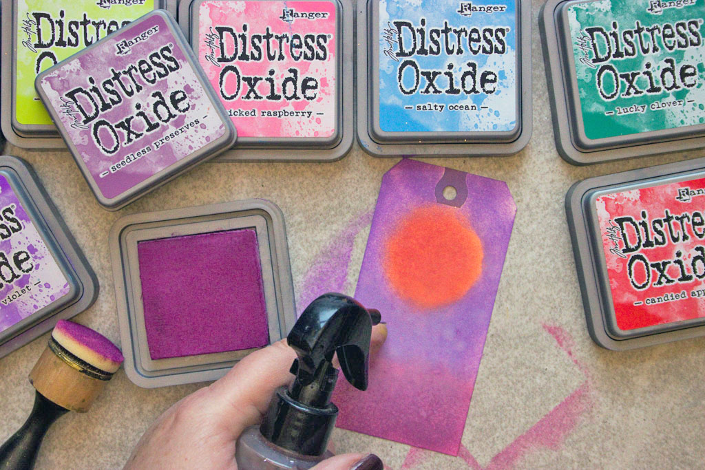 spraying tag with sponge tool and tim holtz distress oxide ink pads