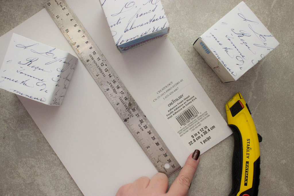 Measuring cardboard with ruler