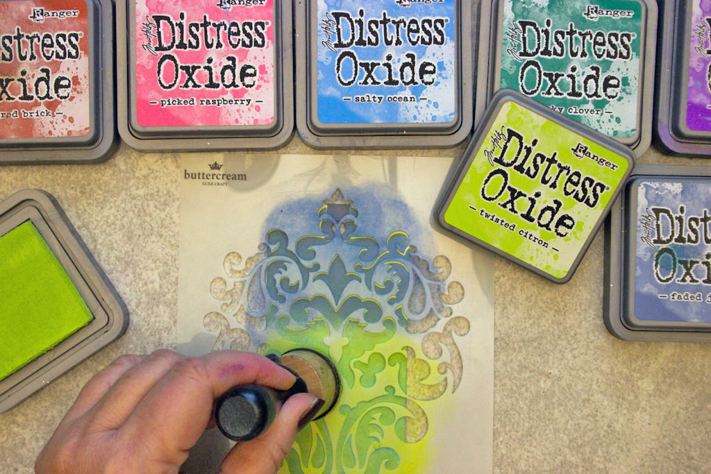 showing distress oxide ink technique with stencil and sponge tool
