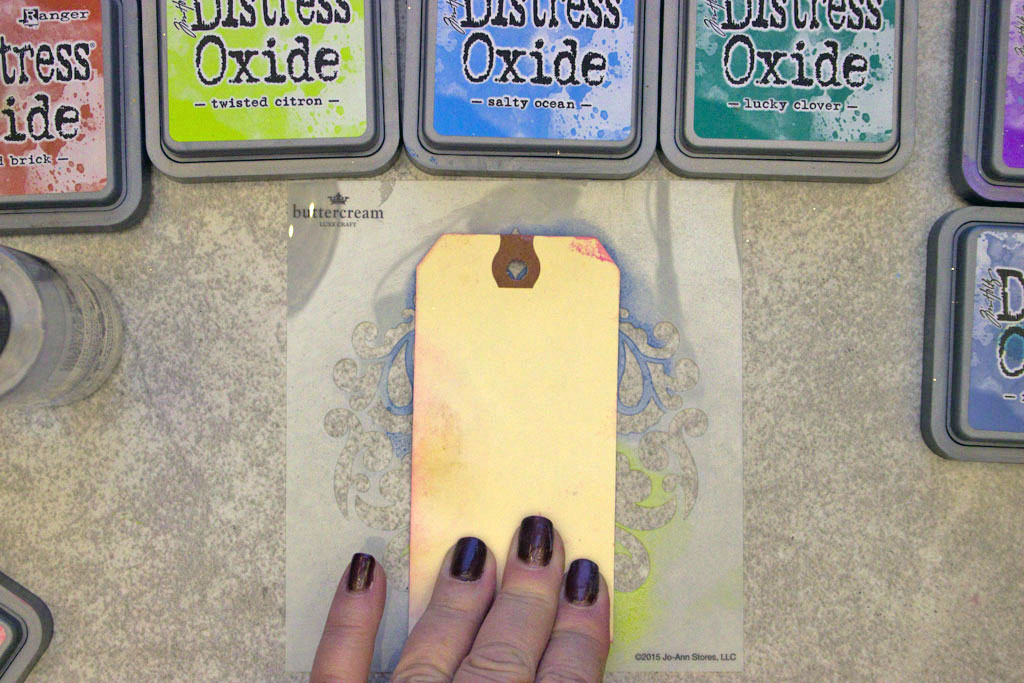 smooshing tag on stencil and distress oxide inks
