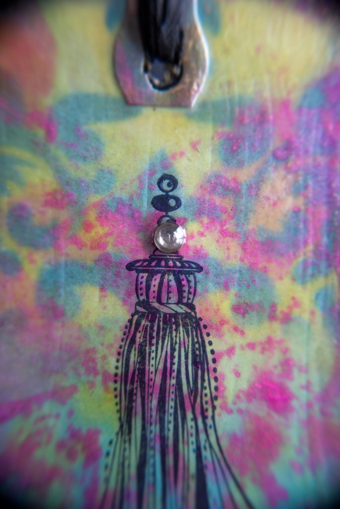 close up of finished distress oxide ink tag with tassel