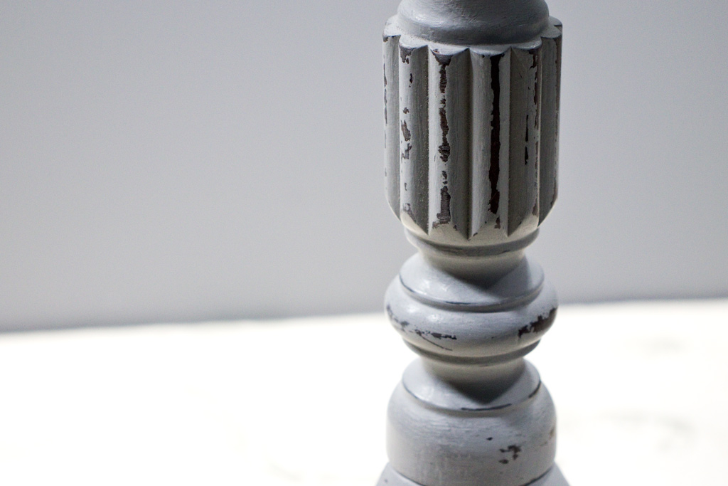 close up of distressed fluted column on table