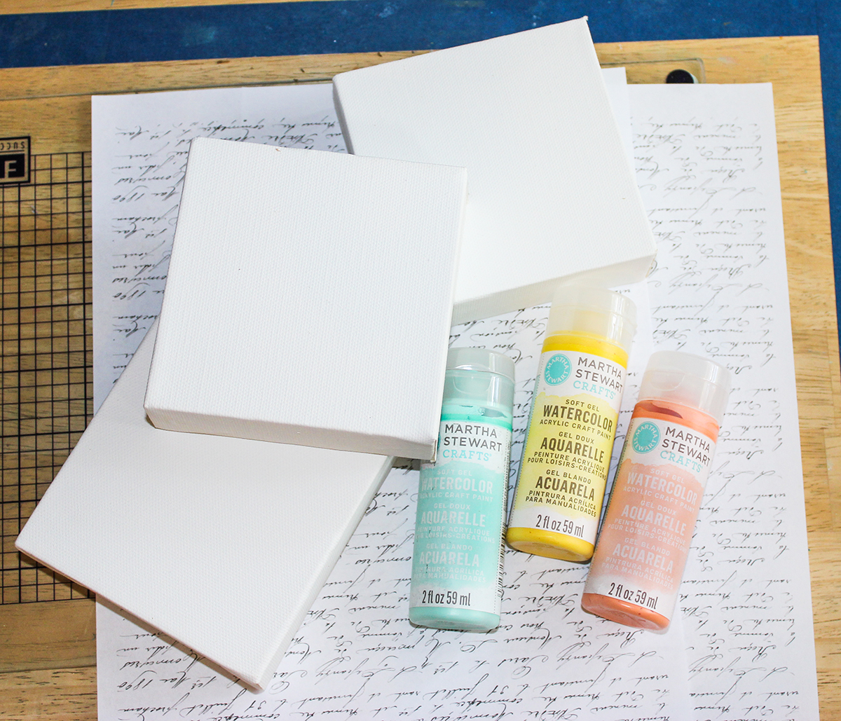 art supplies with paint and script paper