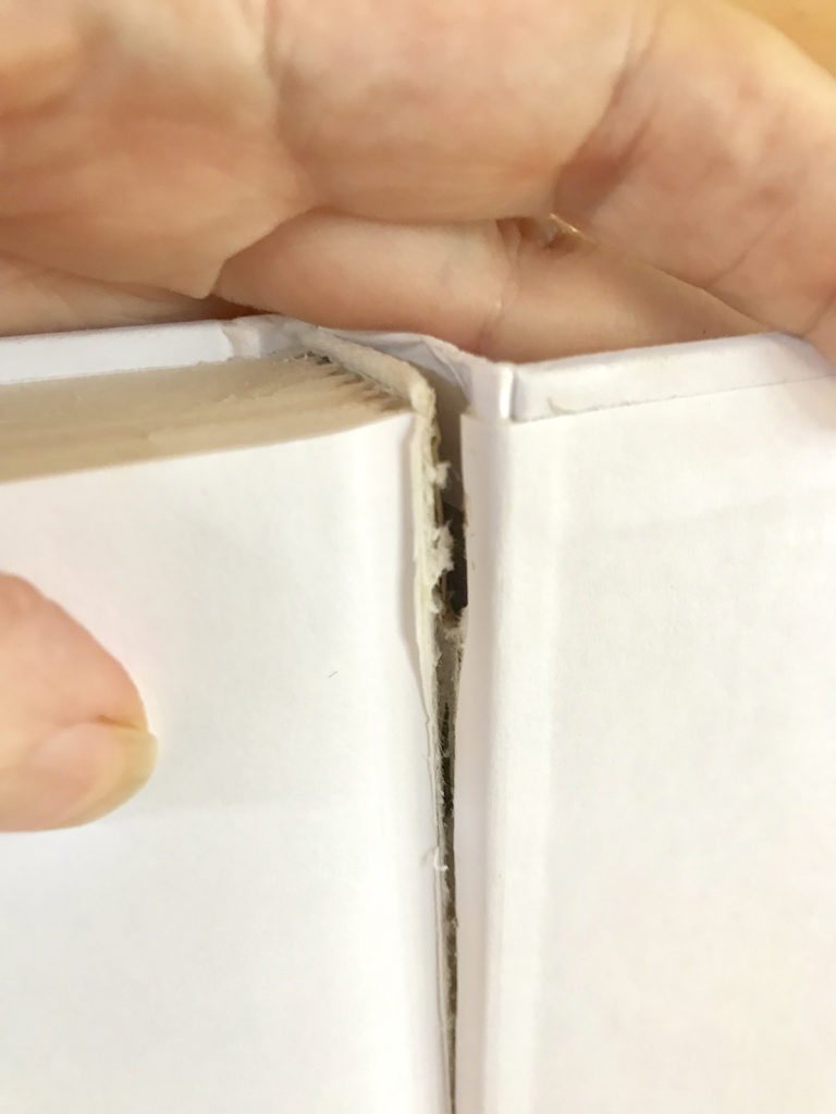 Pulling pages away from book spine