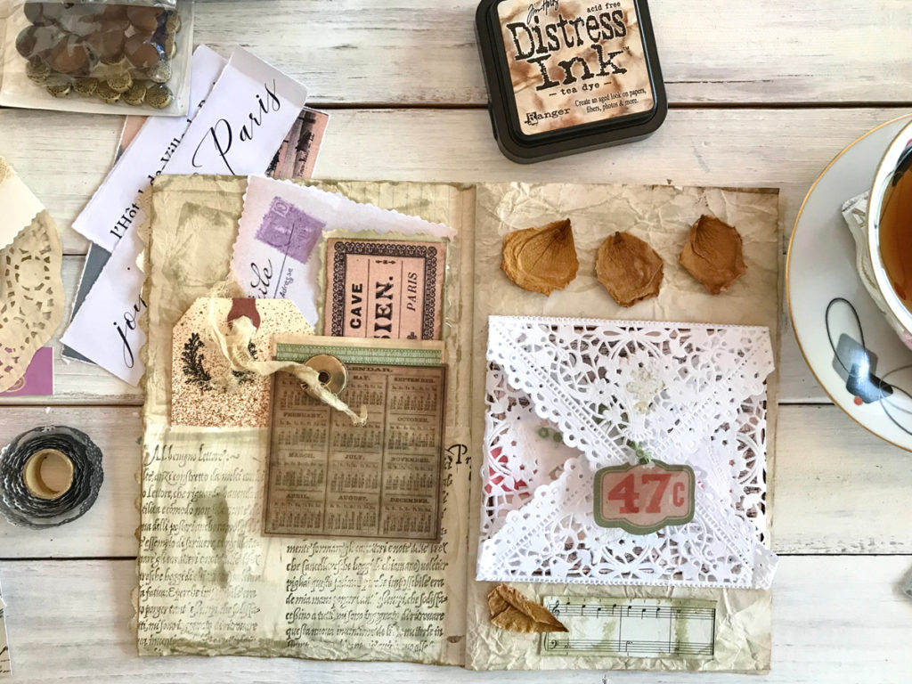 junk journal page with lace envelope and ink