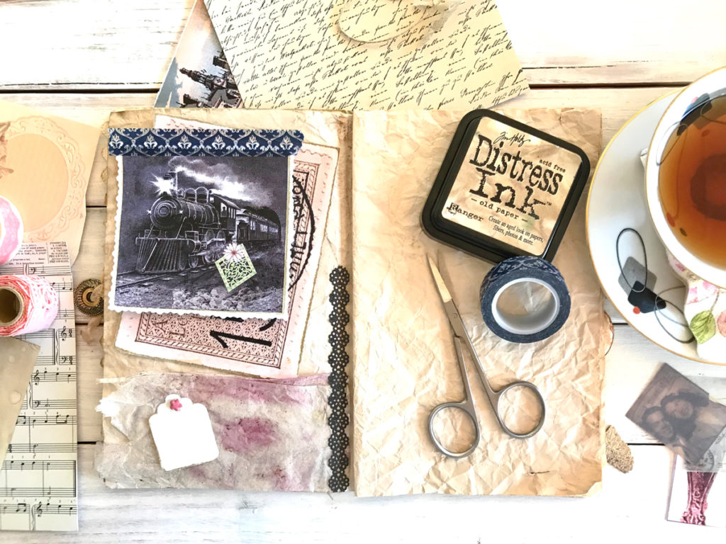 junk journal layout with train and ink and tape and scissors