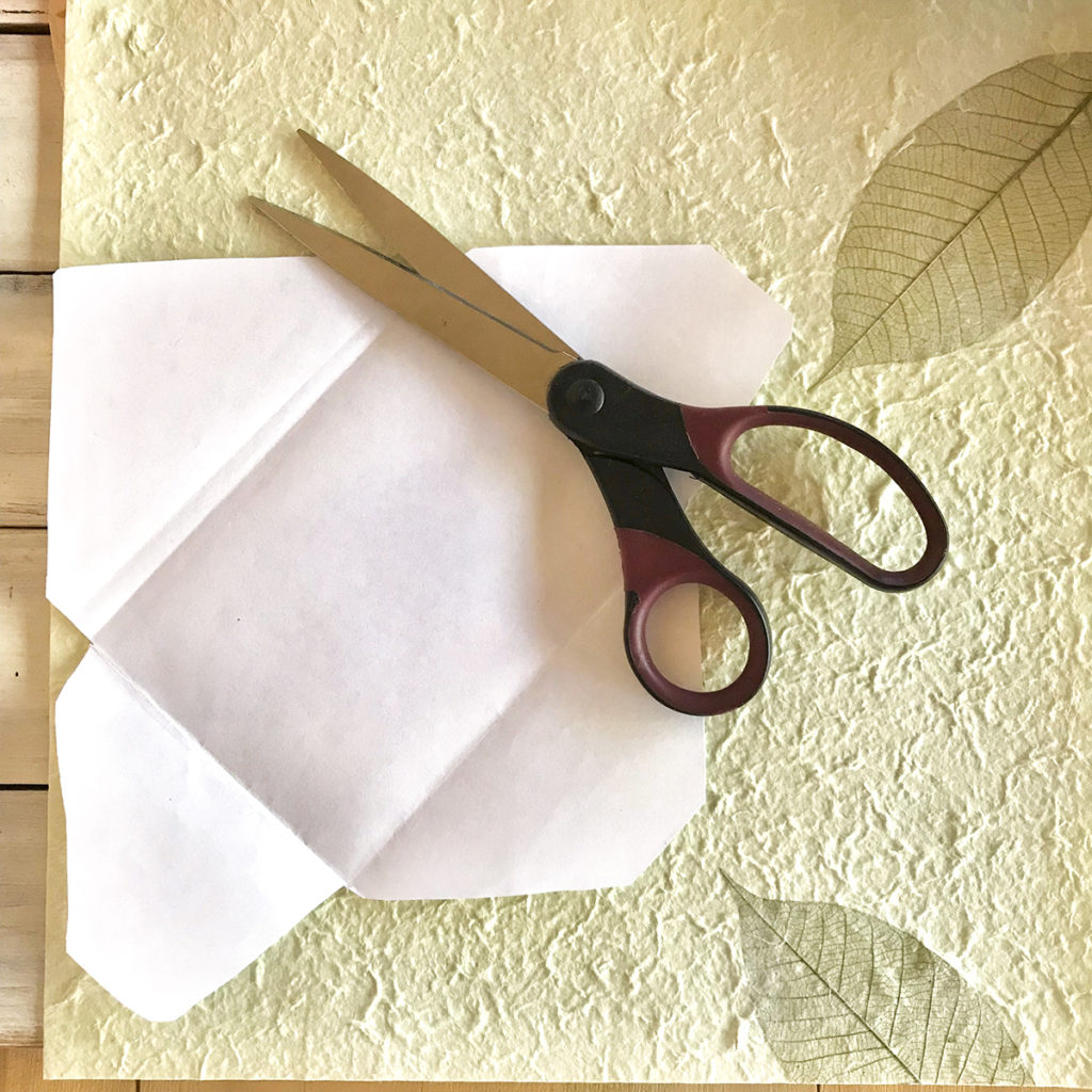 folded envelope with scissors and paper