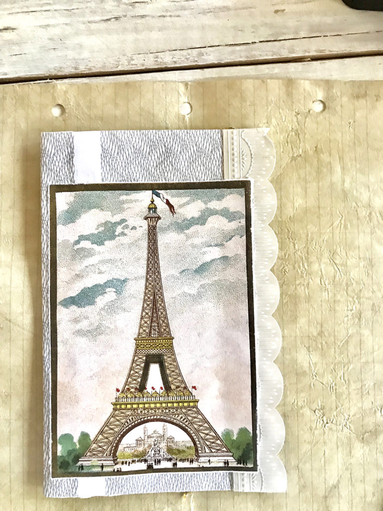 eiffel tower on stack of papers