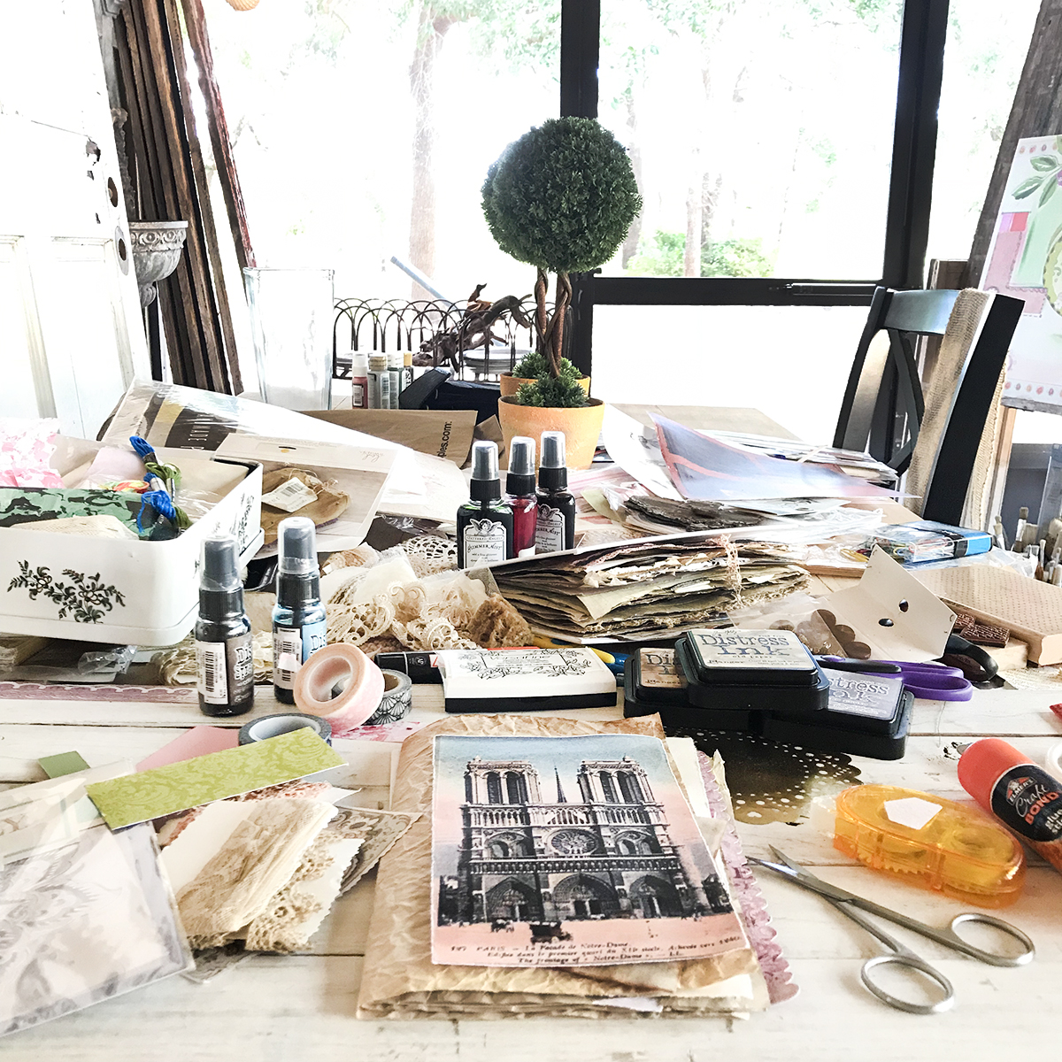 A table with papers and art supplies all over it