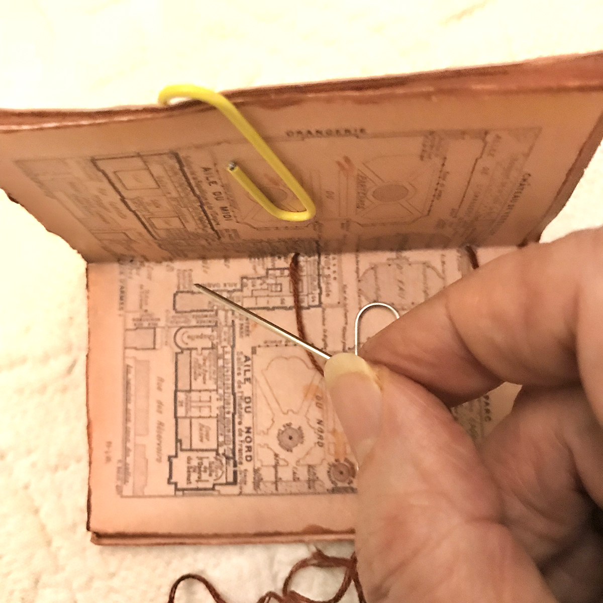 old map made into book with paper clip