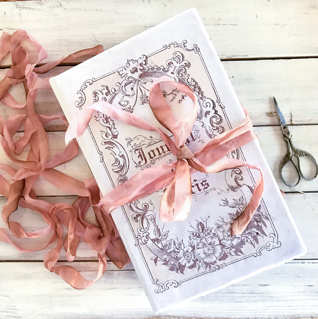 Junk Journal with ribbon tied on it and scissors