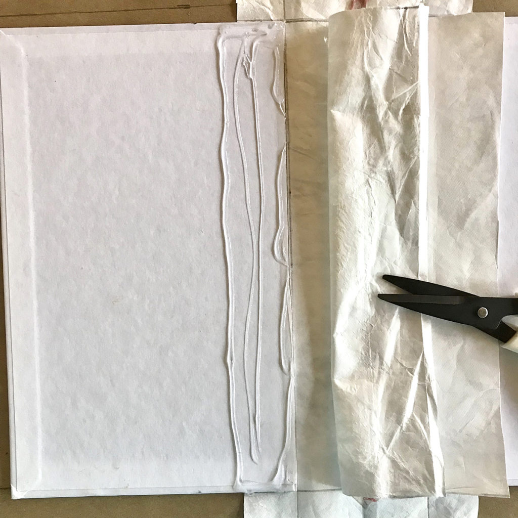 gluing paper to book cover