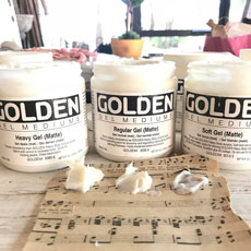 jars of golden's gel medium with sheet music