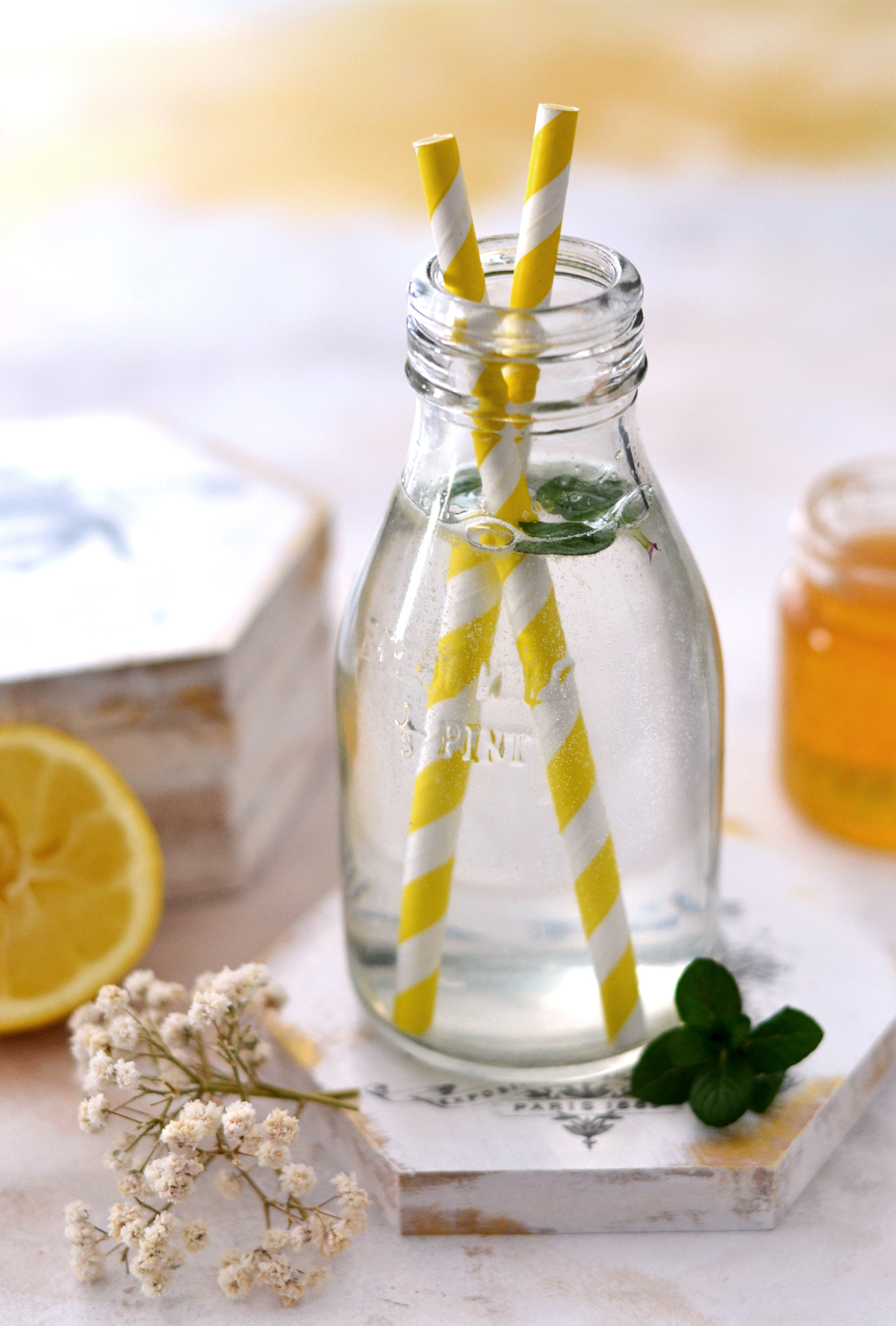 bottle with two yellow striped straws
