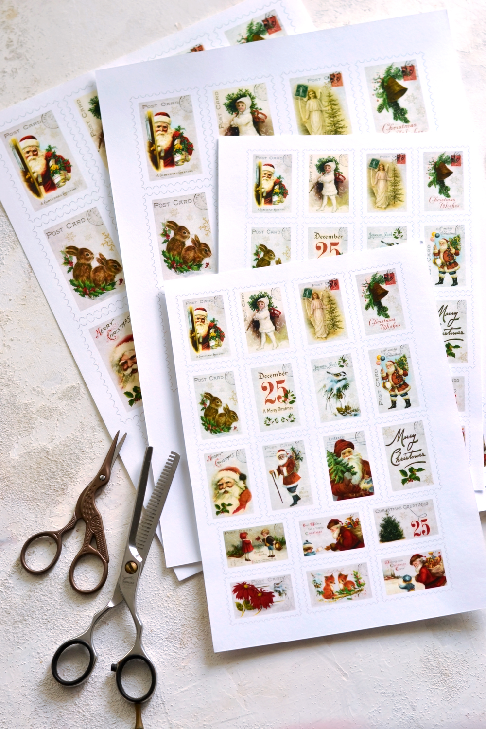 pages of Christmas postage stamps with scissors