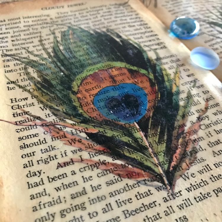 Gloss Medium Over Feather on Book Page
