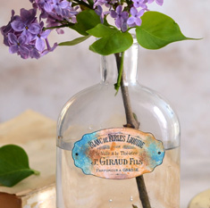 Bottle with French Label and lilacs