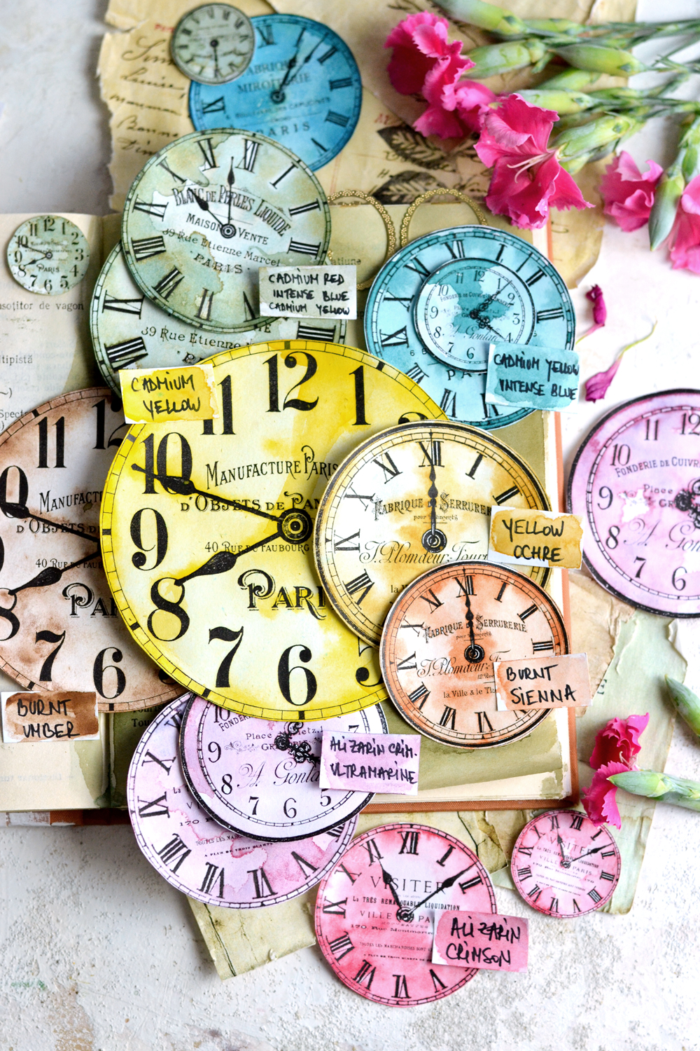 thirteen colored clock faces with flowers