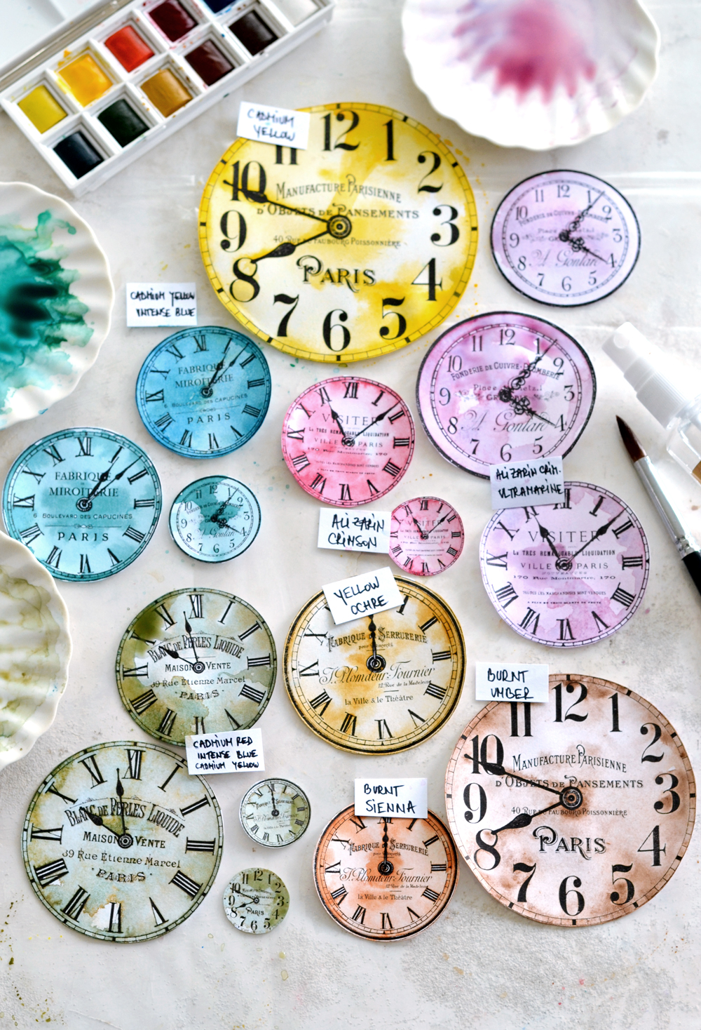 different clock faces with paint brush