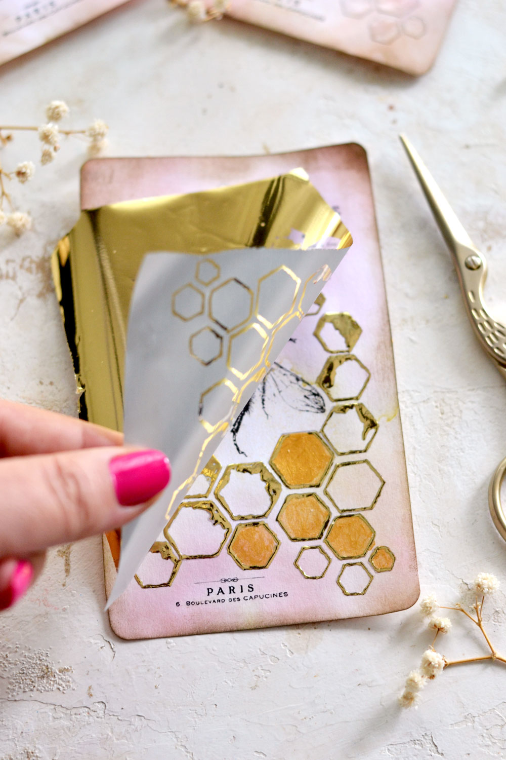 applying gold foil to bee tags