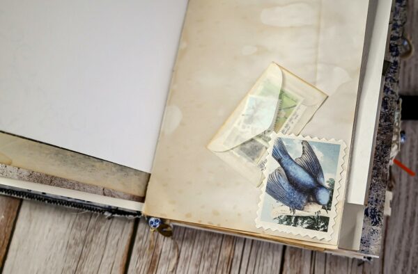 Junk journal spread with blue bird stamp