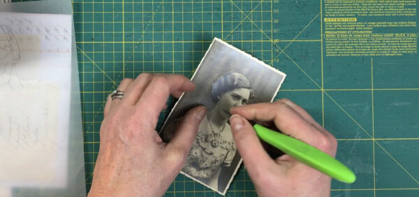 Craft knife cutting a photograph