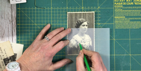 A photograph being traced with a pencil