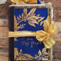 Blue junk journal cover with yellow ribbon