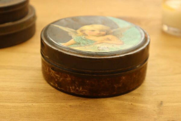round tin with angel on lid