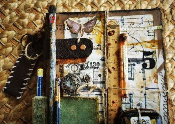 Junk journal cover with paintbrushes attached