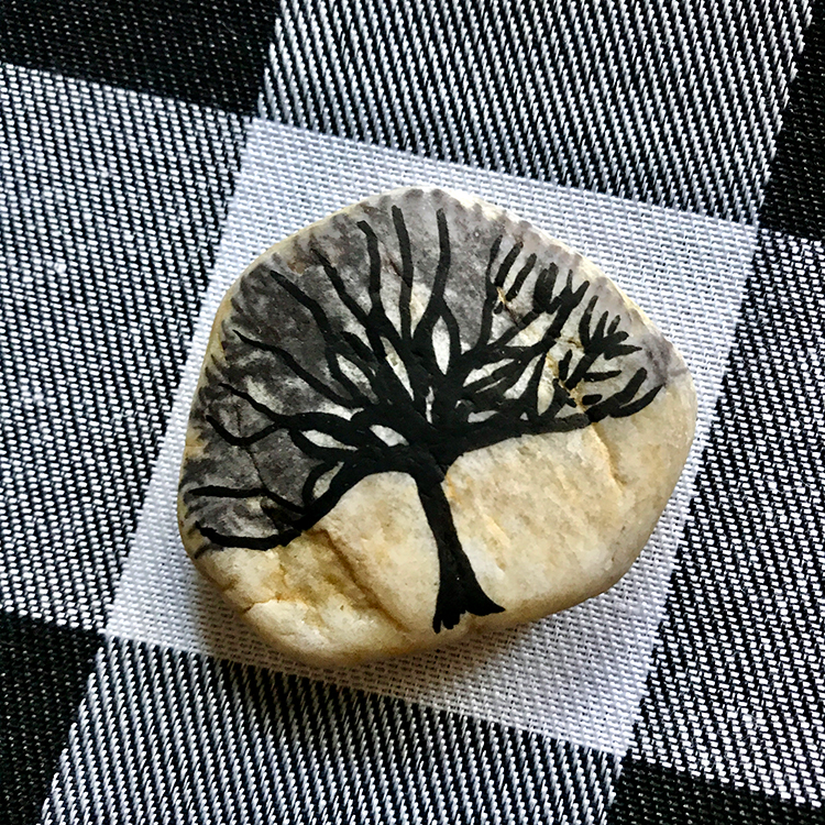 Tree painted on rock in silhouette black and gray